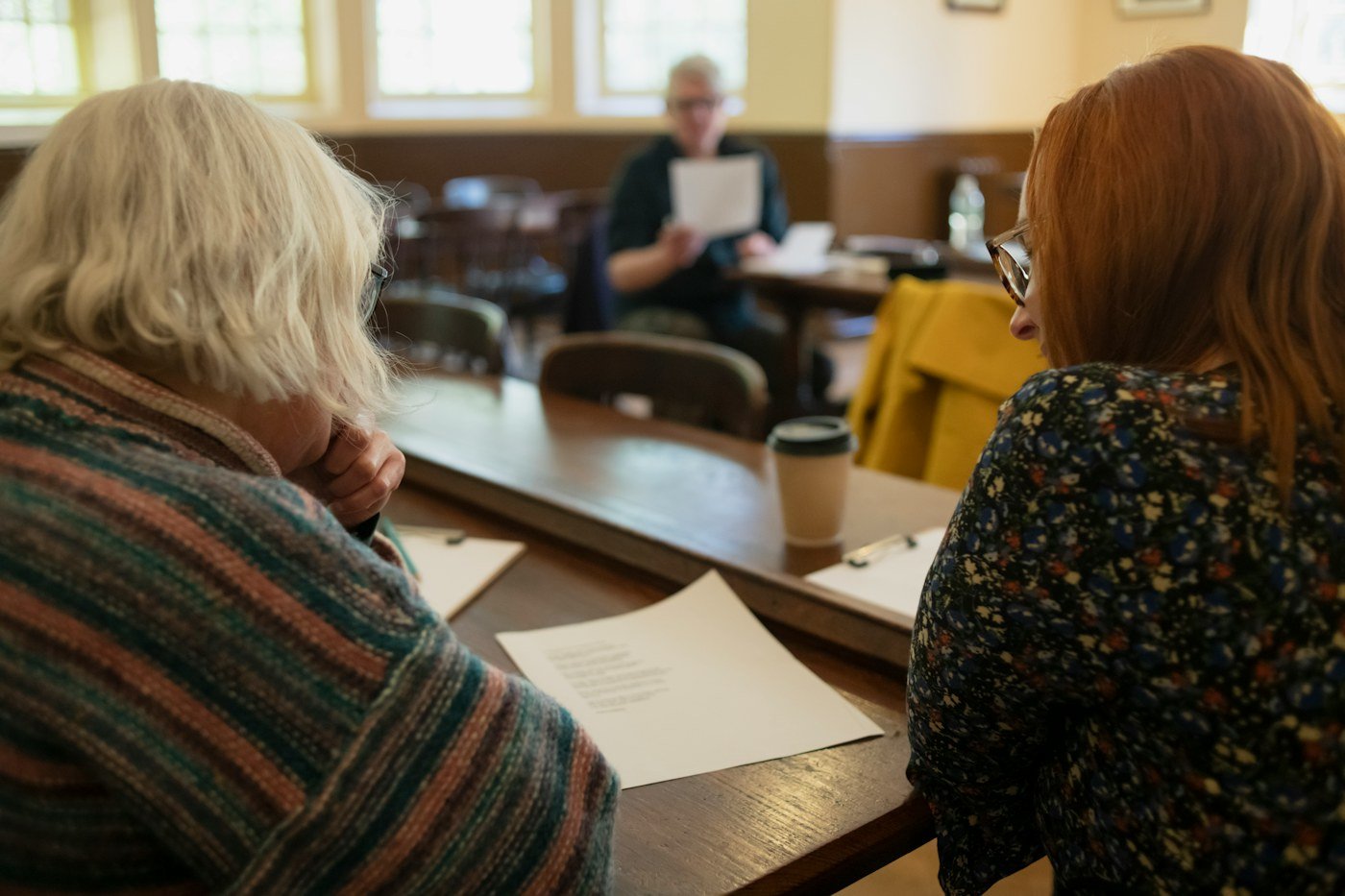 Older mother and adult daughter reviewing senior care information together at a table