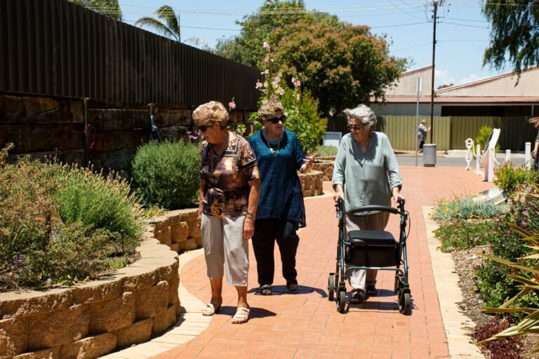 Older women walking together and talking in a sunny park
