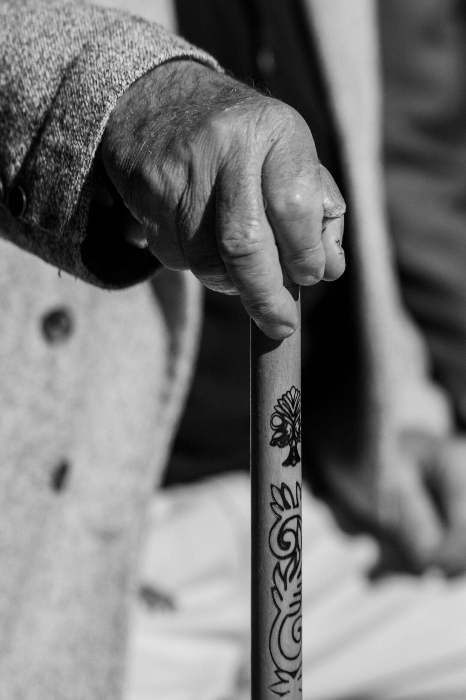 Close-up of a senior adult hand holding a walking cane