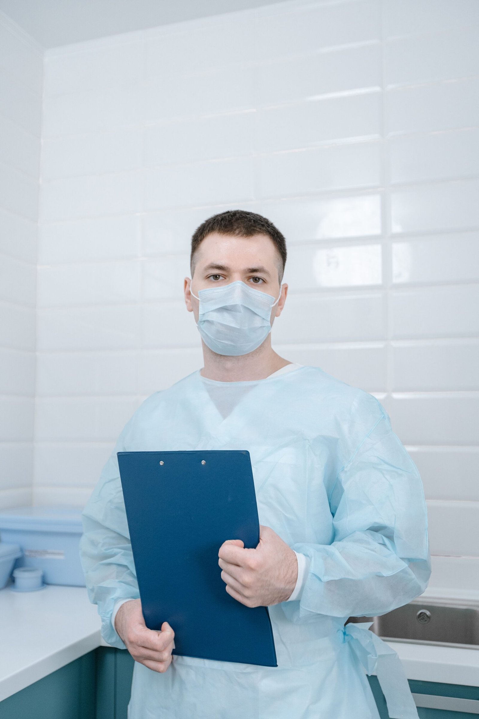 Healthcare professional holding a clipboard indoors.