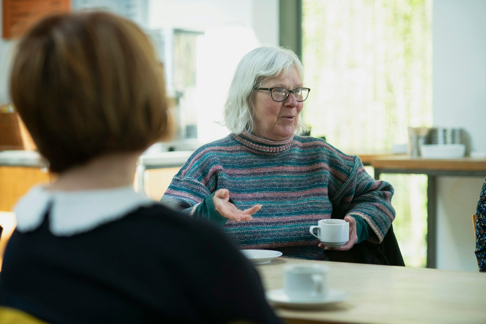 Older woman speaking with a caregiver during a care conversation