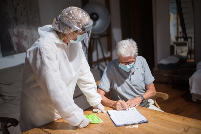 Older adult reviewing paperwork with a healthcare professional