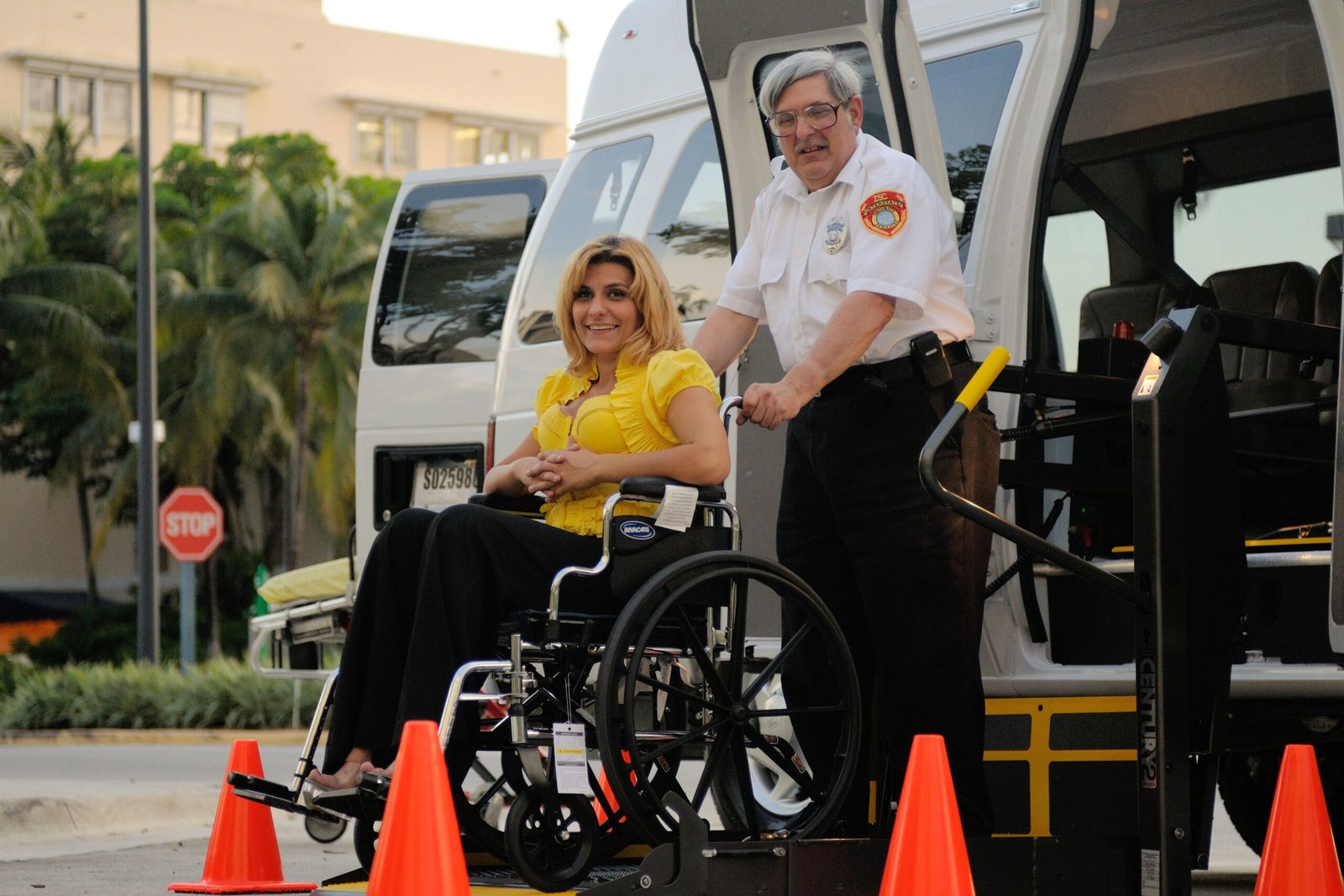 Accessible transportation service assisting a wheelchair user outdoors