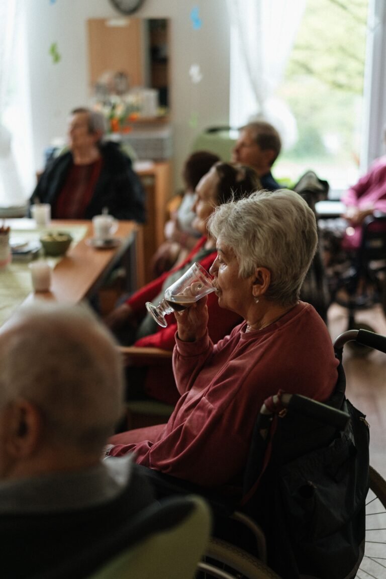 Older adults gathered around a table in a residential care setting