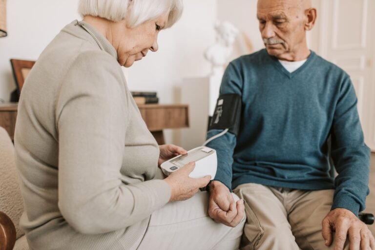 Older couple sitting together at home while checking their health