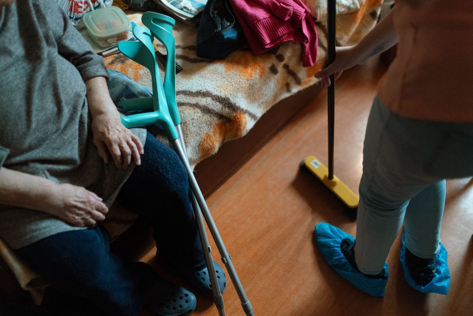 Caregiver assisting an older woman with daily household care