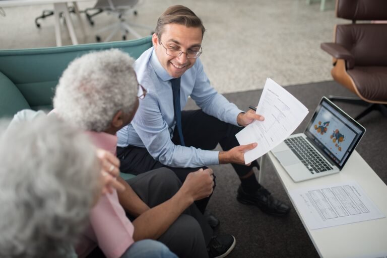 Older adults reviewing care and pricing documents with an advisor