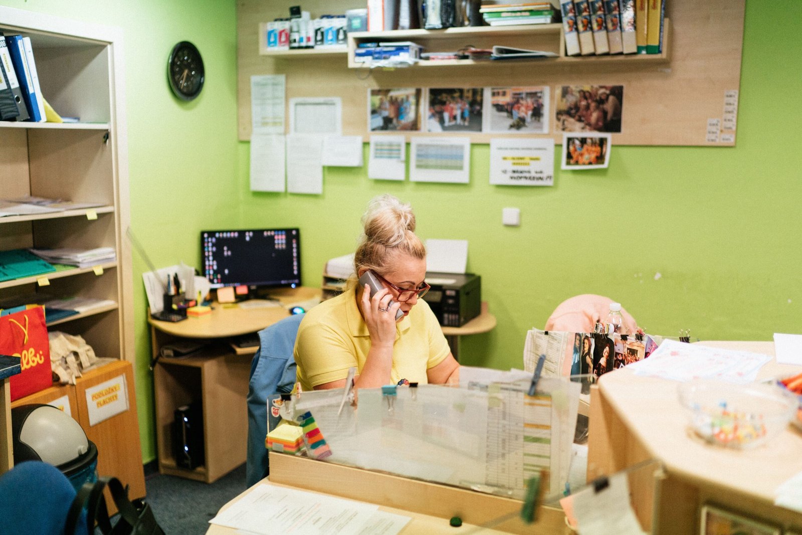 Caregiver speaking by telephone at a nursing home reception desk