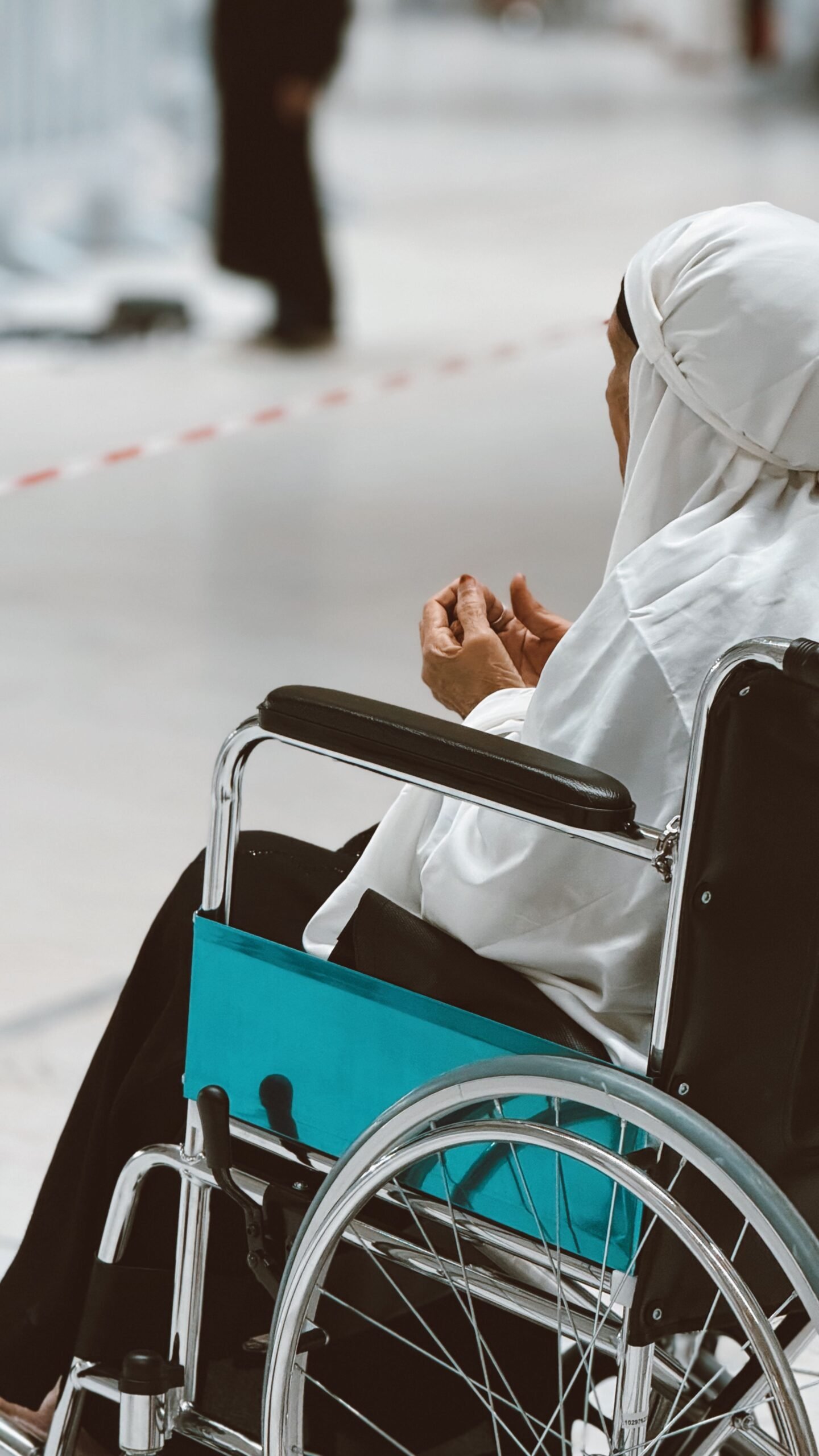 Older adult using a wheelchair indoors.