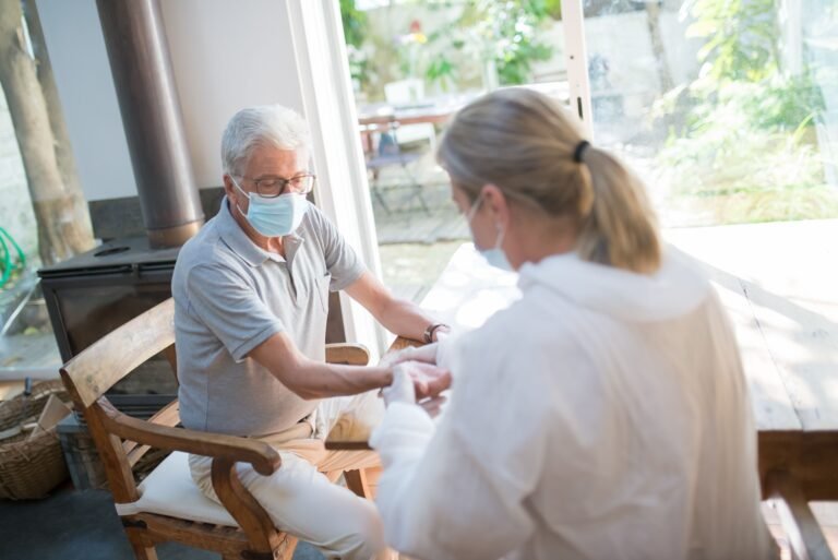 Doctor visiting an older adult in a home setting.