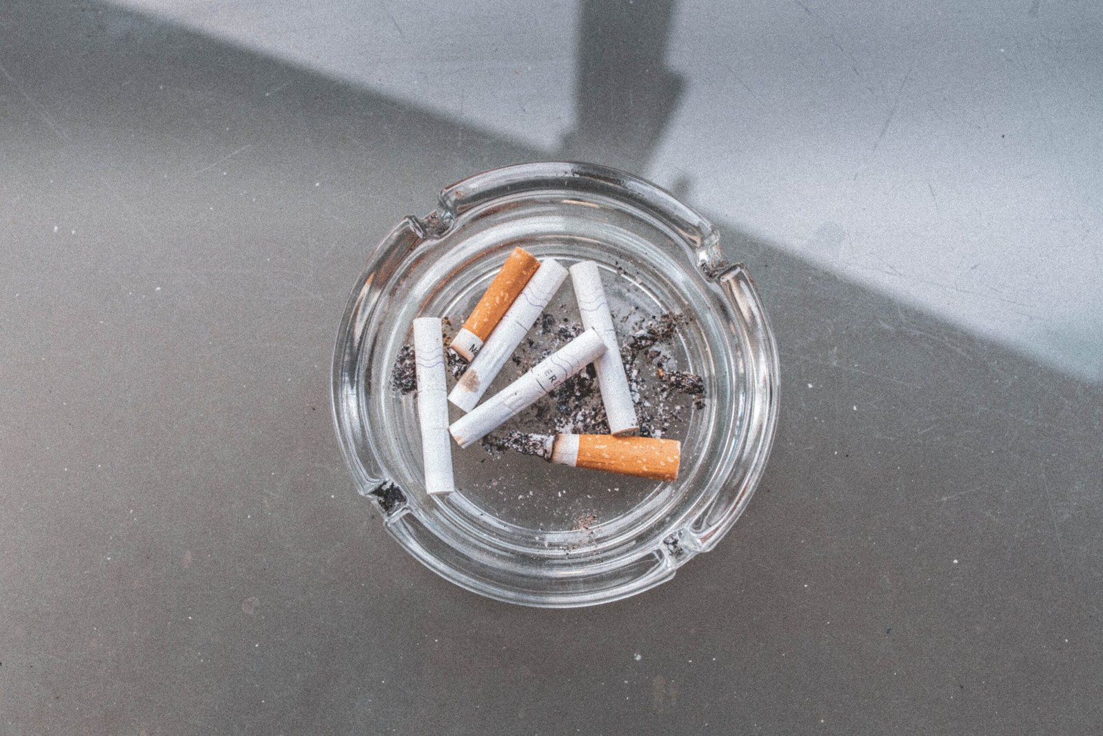 Ashtray with cigarette butts illustrating a smoking policy topic.