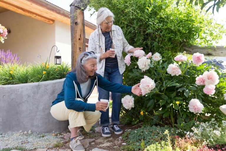 Two women enjoying flowers together in a garden