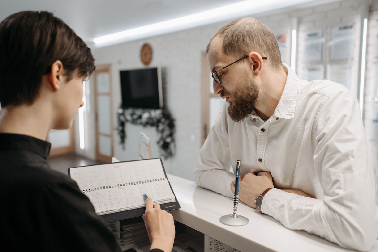 Reception desk appointment planning with an open calendar