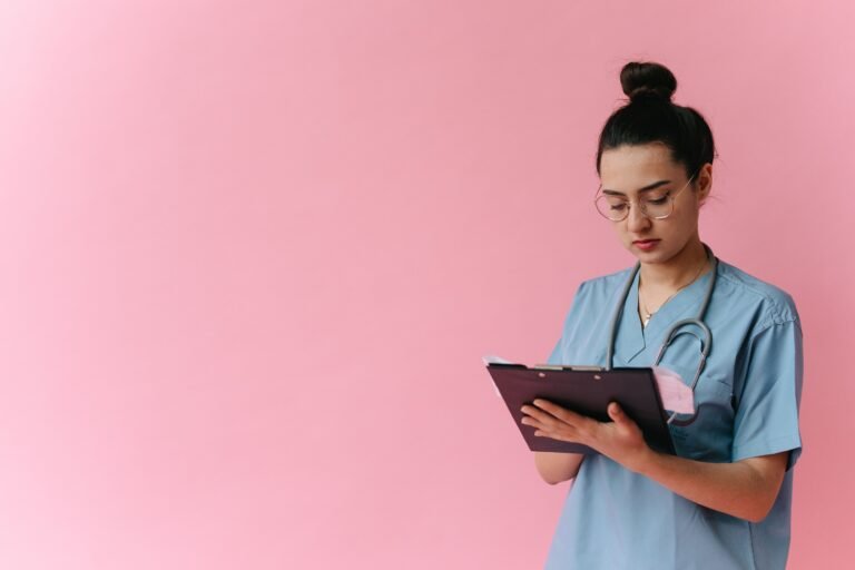 Healthcare professional reviewing notes on a clipboard.