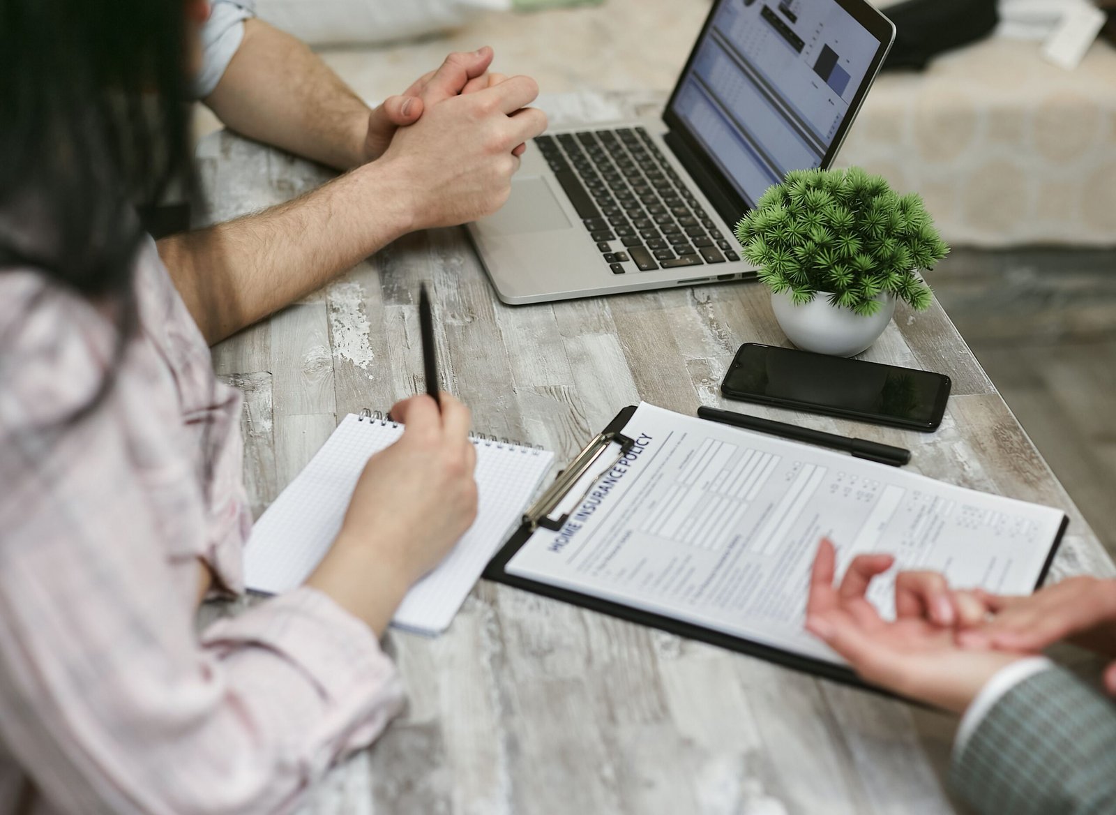 People reviewing insurance documents together at a desk.