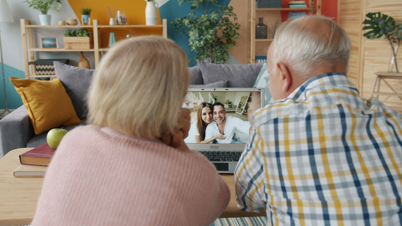 Family members using a laptop for a caregiving conversation