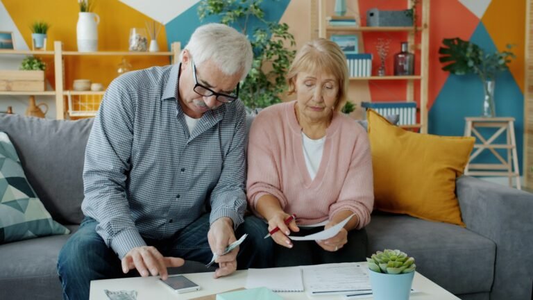 Older couple reviewing financial papers and household bills