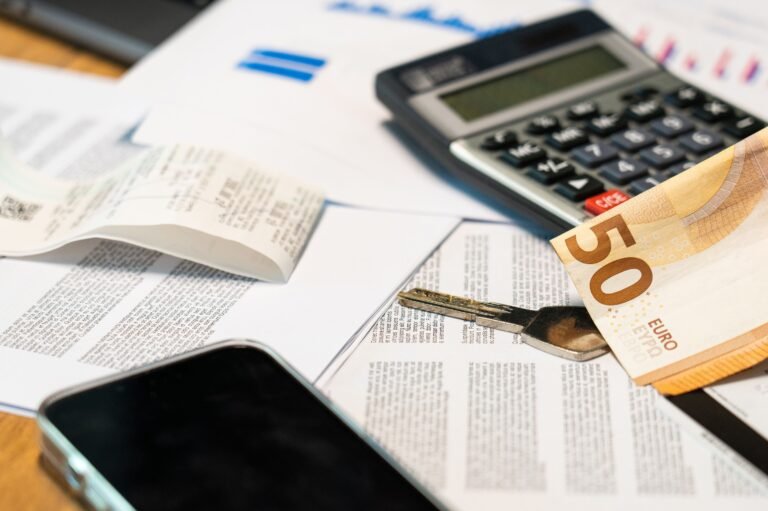 Calculator and financial documents arranged for travel and budget planning.