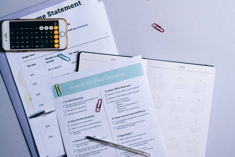 Calculator and financial planning documents arranged on a desk.