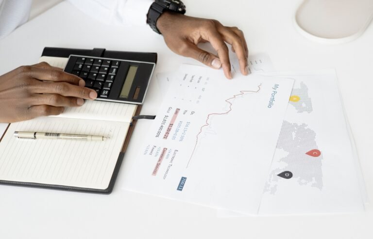 Calculator positioned beside financial planning documents.