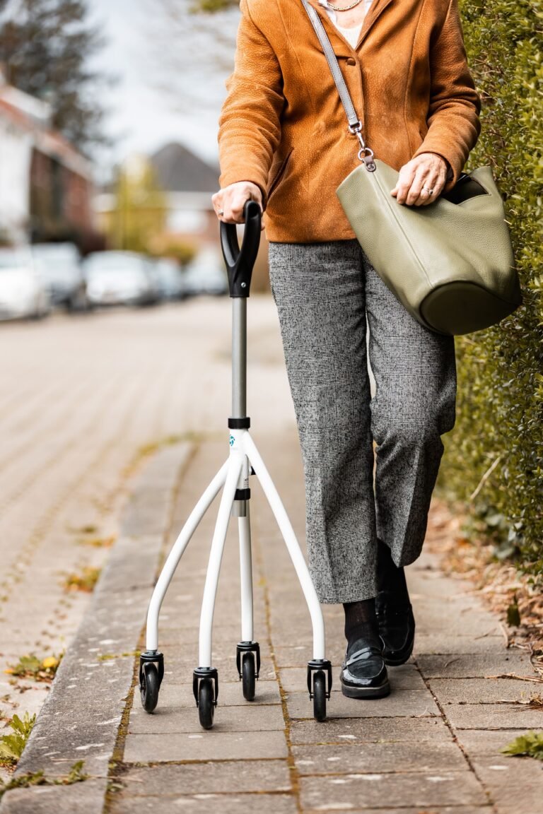 Older woman walking with a rollator during mobility recovery