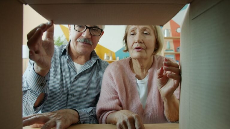 Older couple opening a moving box together at home