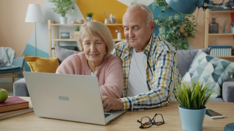 Older couple using a laptop for a remote family check-in