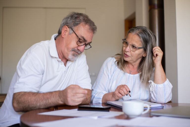 Older couple reviewing paperwork and financial records together
