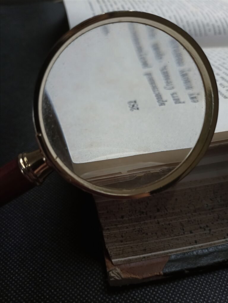 Magnifying glass positioned over printed text in an open book