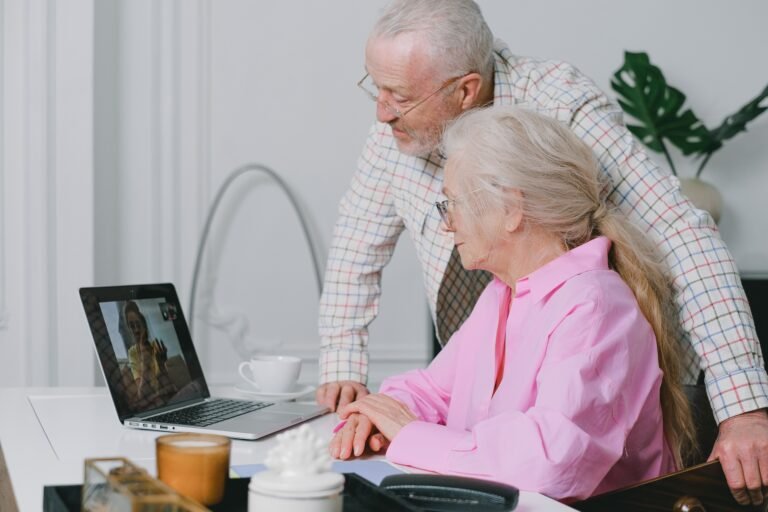 Older couple using a laptop together at home.