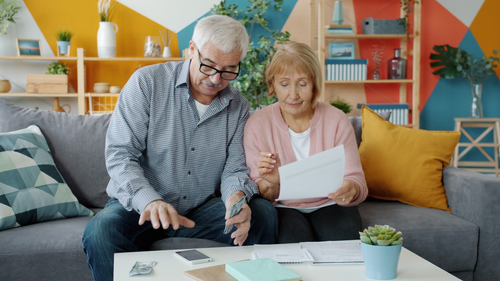 Older couple reviewing financial documents together at home