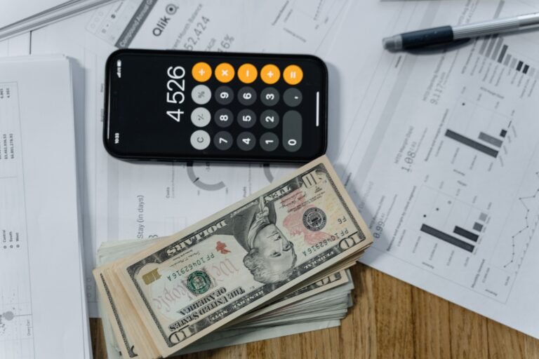 Cash, calculator, and financial papers arranged for a renewal review.