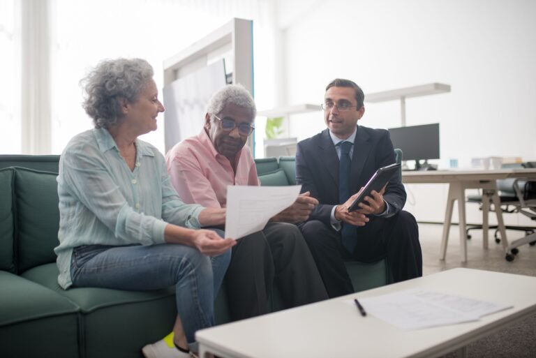 Older couple discussing documents with a professional advisor
