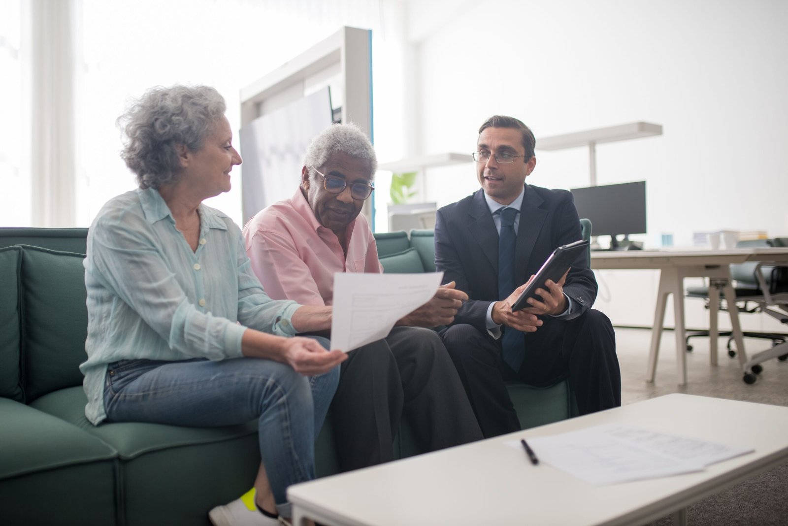 Older couple discussing documents with a professional advisor