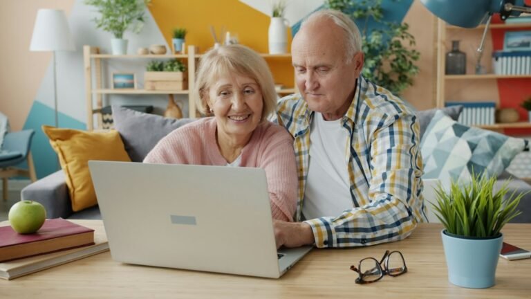 Older couple using a laptop together to research information