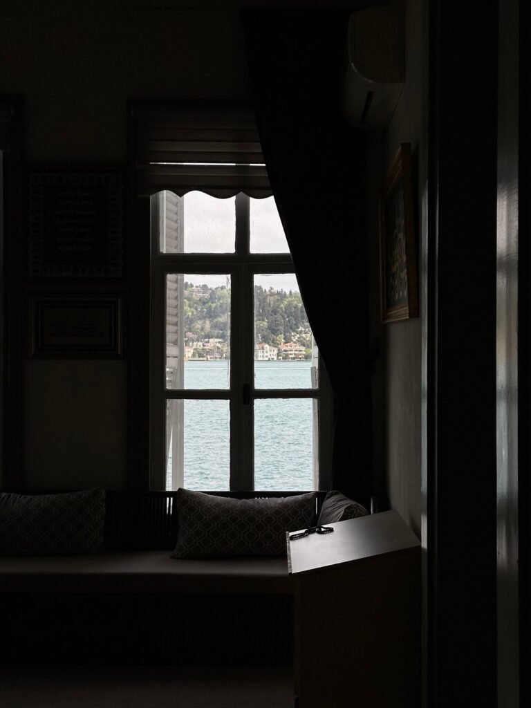 Quiet window-lit interior with seating and a peaceful view.