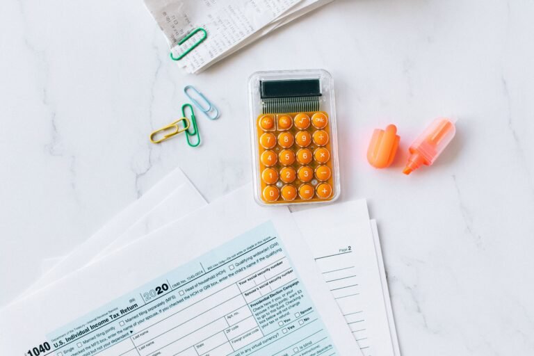 Financial and claim-style documents arranged with a calculator on a desk.