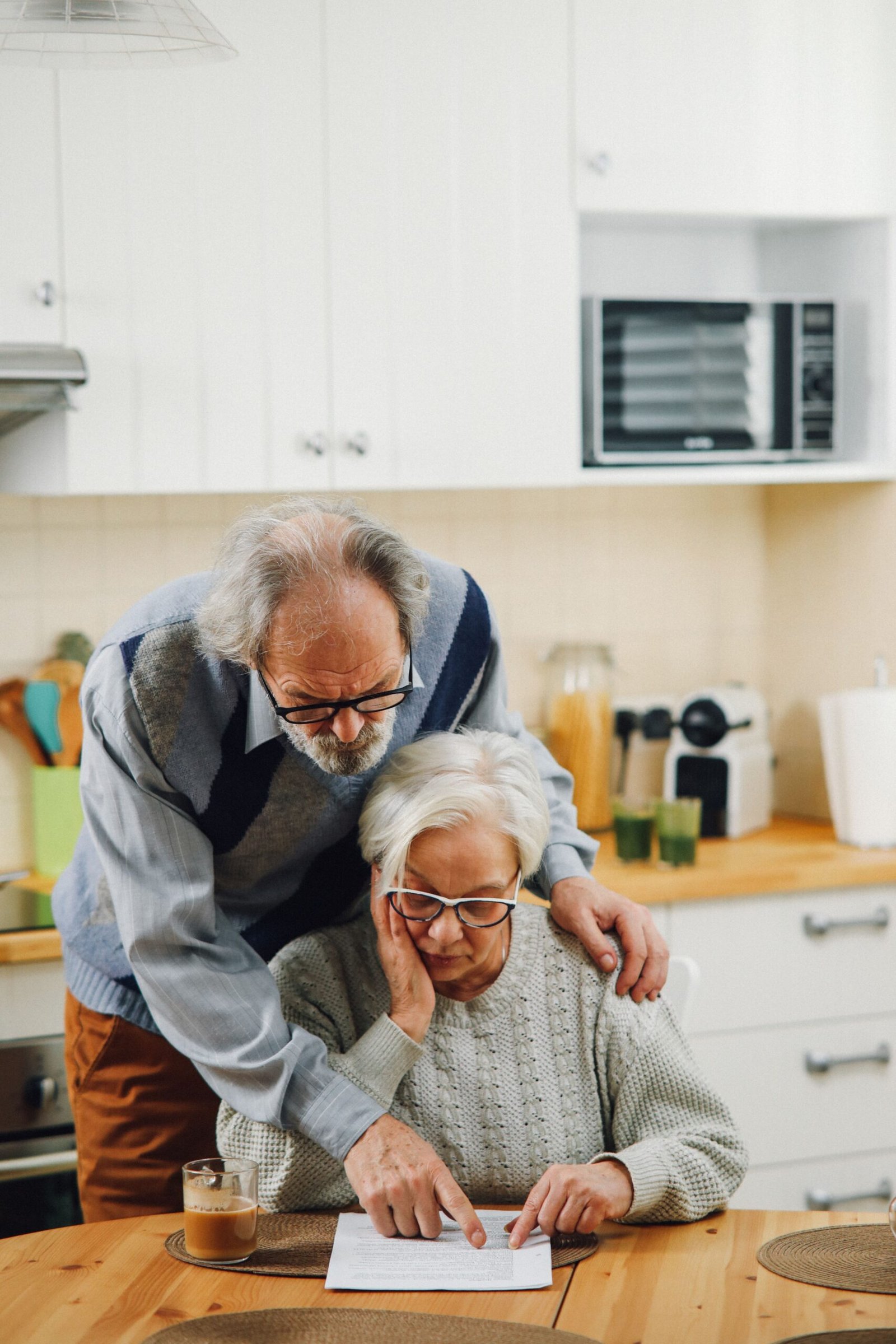 Older couple reviewing financial documents together at a table