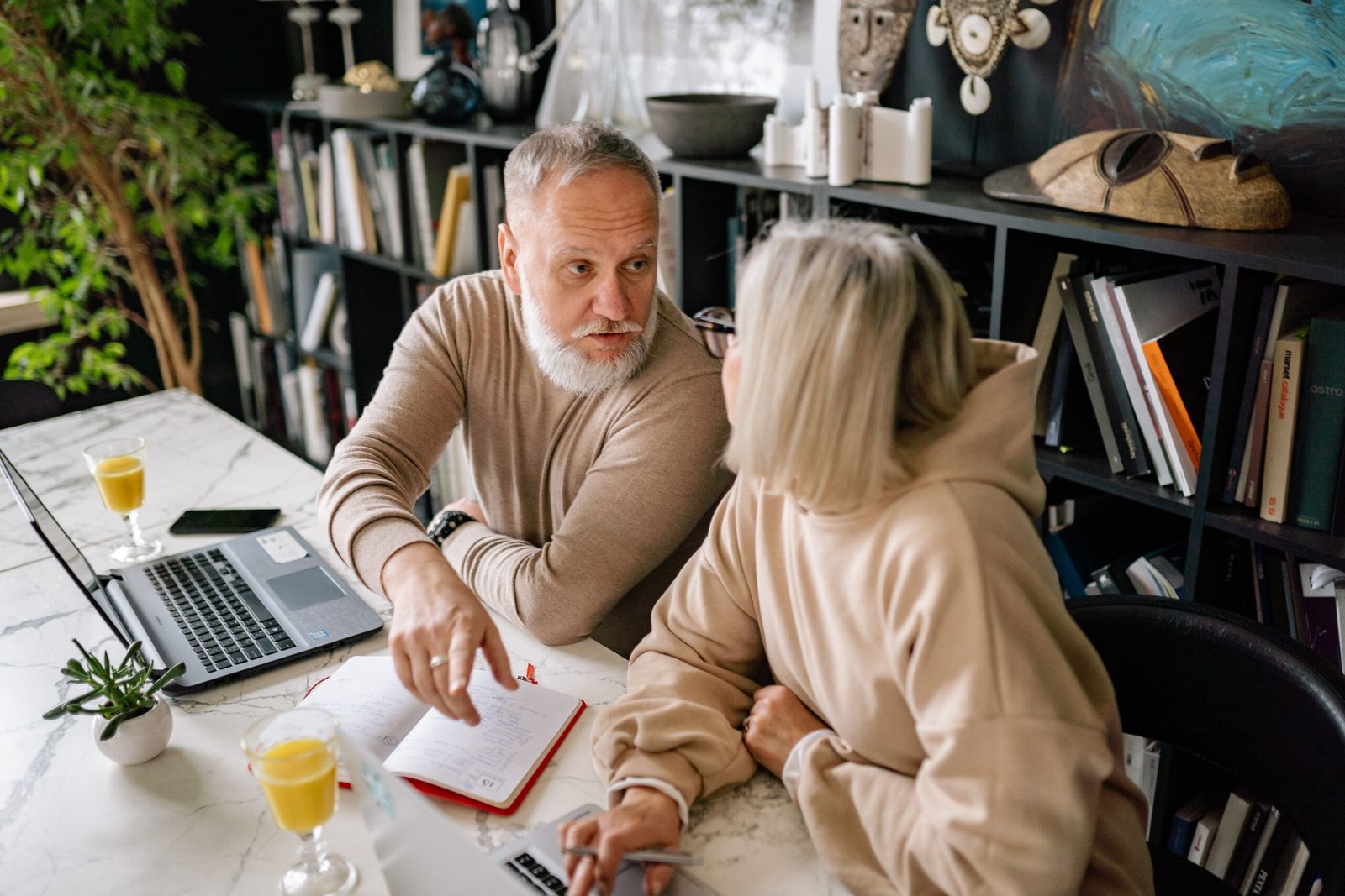 Older couple talking together at a home office.