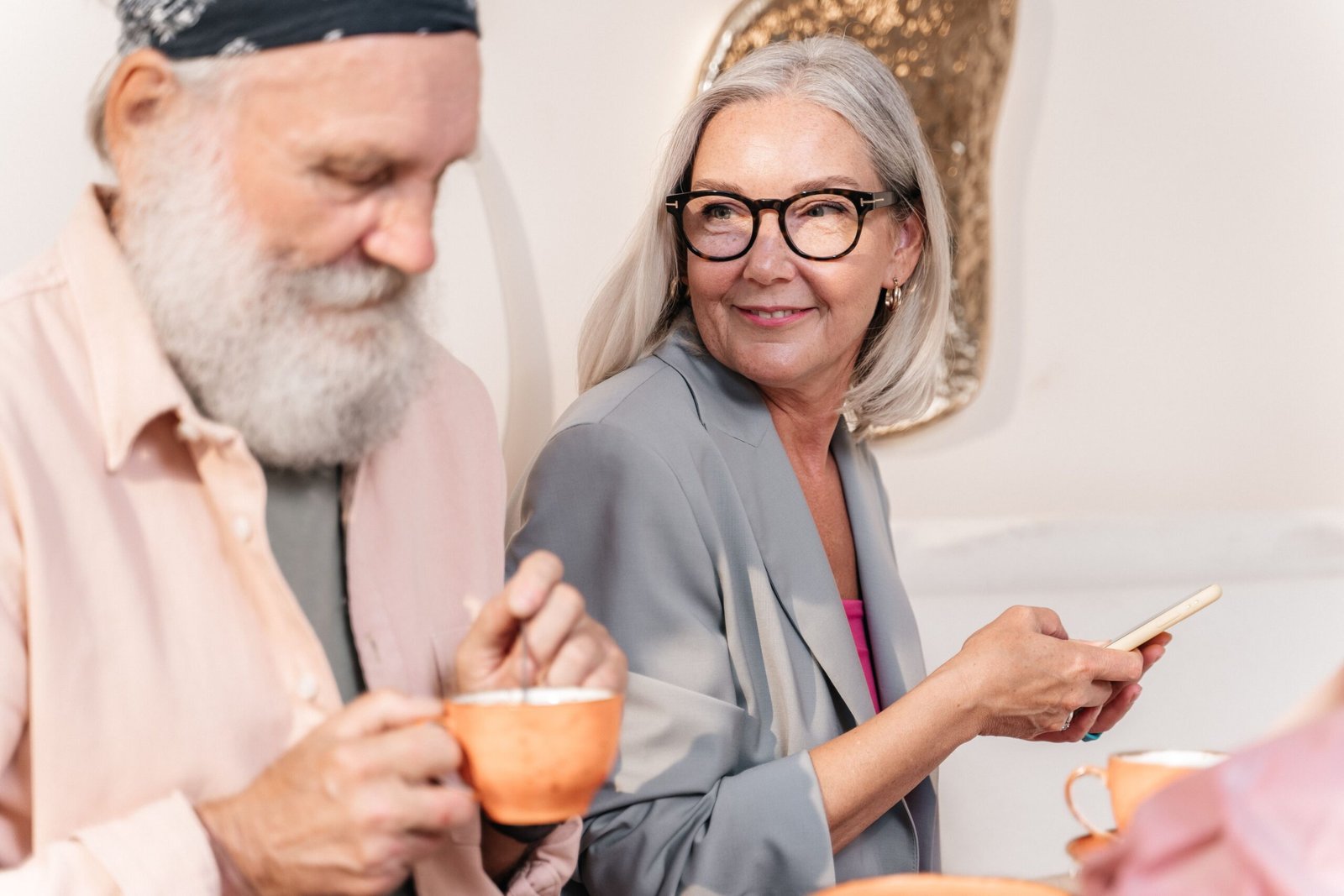Older couple enjoying tea and conversation at home.