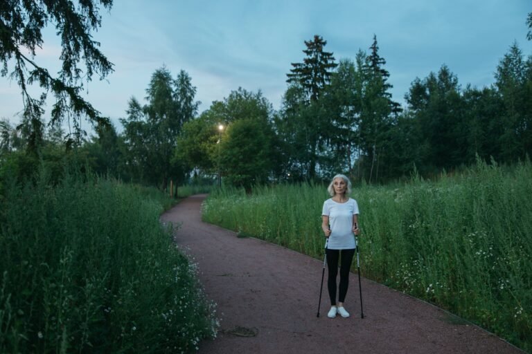 Older woman walking along a peaceful green park path