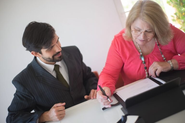 Older woman reviewing important admission paperwork with a professional