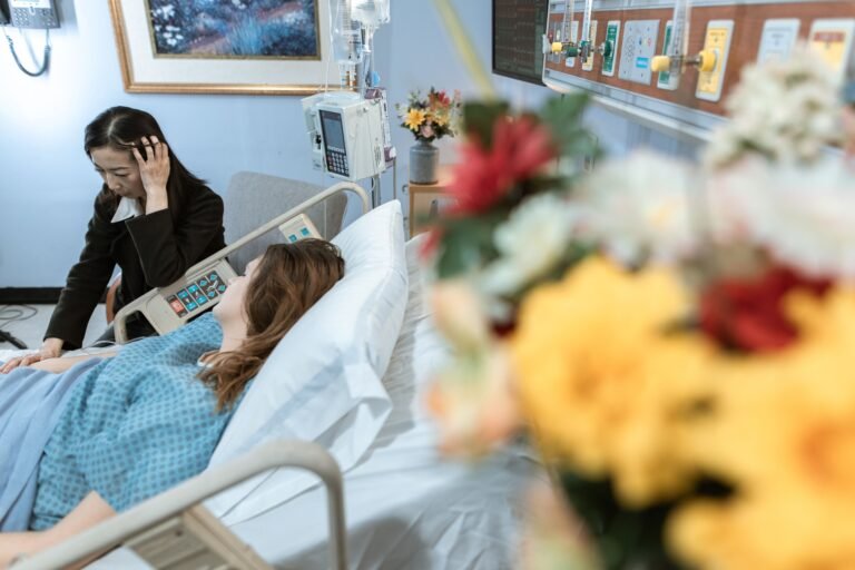 Family member visiting an older patient in a hospital room