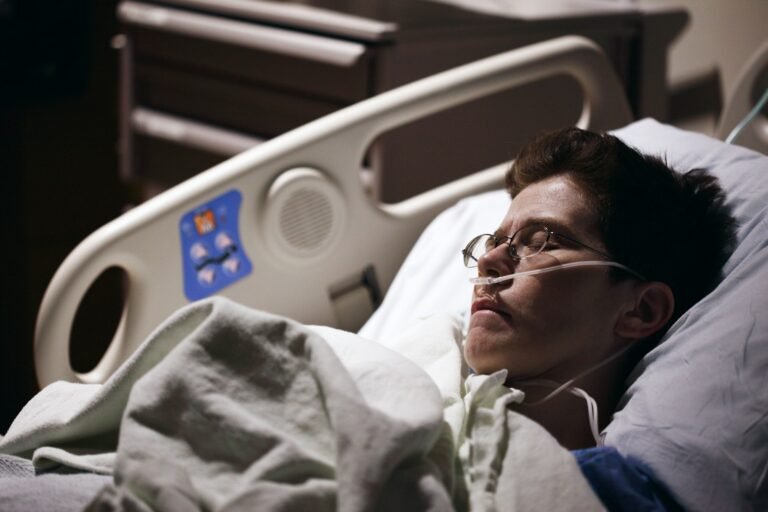 Patient resting in a medical bed during recovery