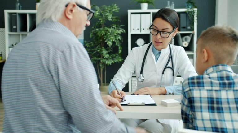 Doctor discussing healthcare information with an older man and family member