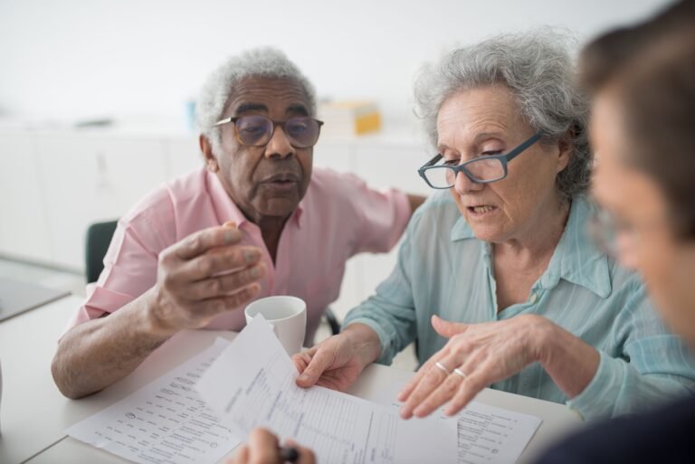 Older couple reviewing documents with a professional