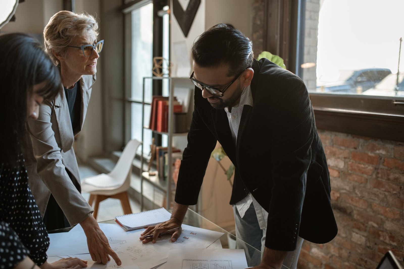 Older woman speaking with another adult during a professional meeting