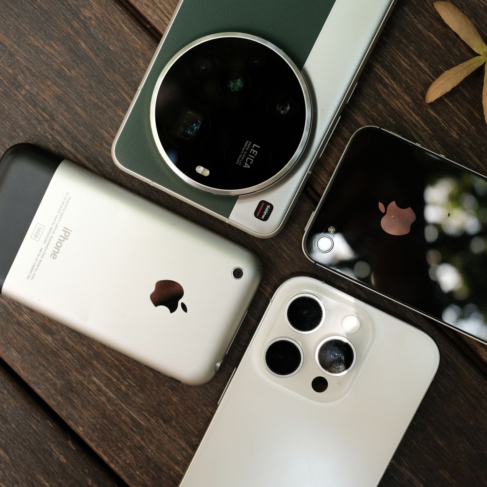 Several smartphones arranged together on a wooden table