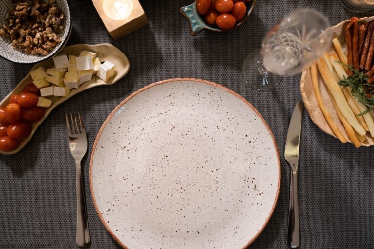 Empty plate and cutlery arranged on a dining table