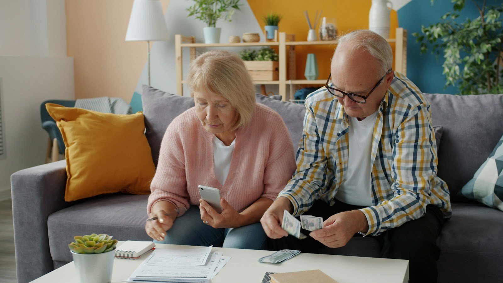 Older couple reviewing bills and financial paperwork together